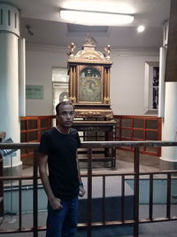 Portrait of young man standing in building