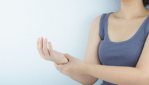 Midsection of woman against white background