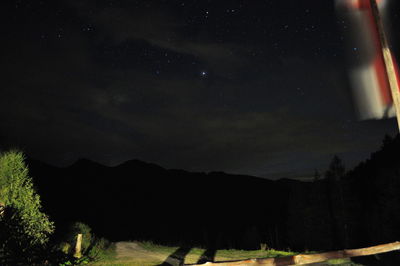 Scenic view of landscape against sky at night