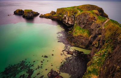 High angle view of rock formations in sea