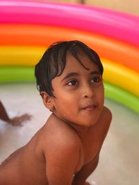 Portrait of shirtless boy in water