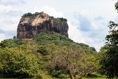 Low angle view of rock formation against sky