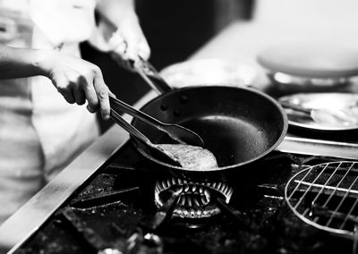 Cropped hand of man preparing food