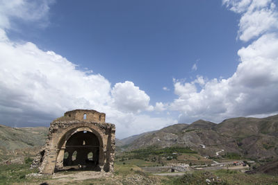 Old castle on mountain against sky