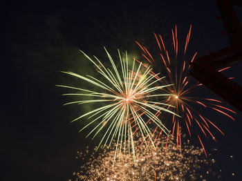 Low angle view of firework display at night