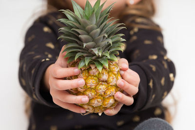 Close-up of hand holding fruits