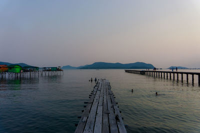 Pier over lake against sky