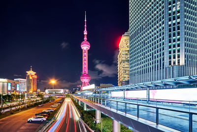 Oriental pearl tower against sky in city at night