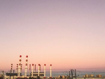 Factory against clear sky during sunset