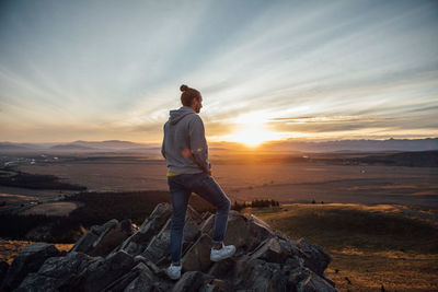 Rear view of man standing on cliff