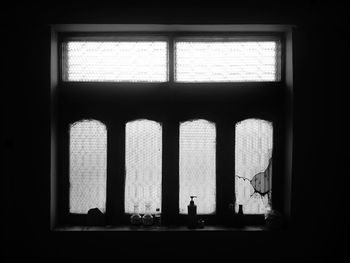 Silhouette people in building seen through window
