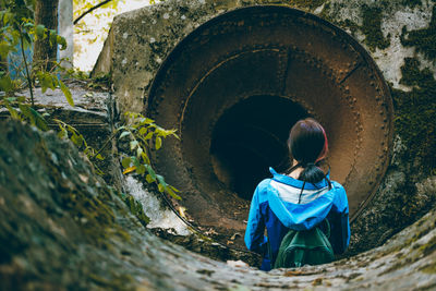 Woman standing in front of pipe