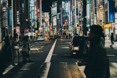 People walking on road in city