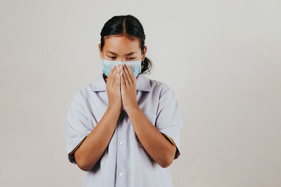 Portrait of girl standing against white background