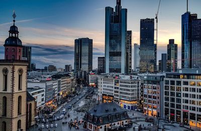 Panoramic view of buildings in city at sunset