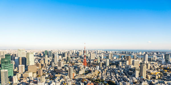 Aerial view of cityscape against clear sky during sunset