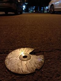 Close-up of illuminated lighting equipment on road at night