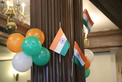Low angle view of multi colored balloons and indian flag 