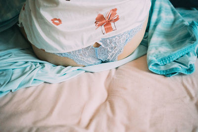 High angle view of woman lying on bed