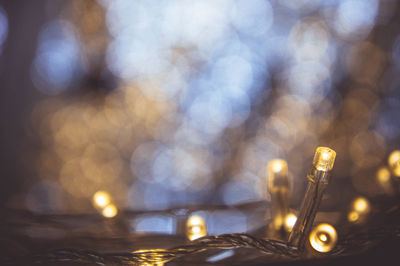 Defocused image of illuminated lights on table