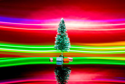 Digital composite image of illuminated lights against colored background