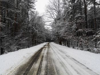 Road amidst snow covered land