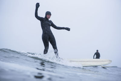 Woman surfing during winter snow