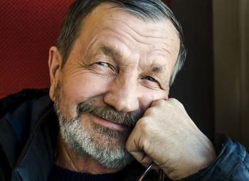 Close-up portrait of senior man in train