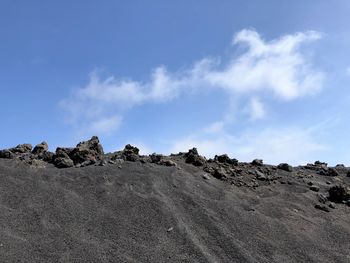 Low angle view of rocks against sky