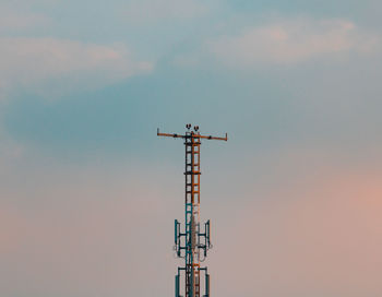 Low angle view of communications tower against sky