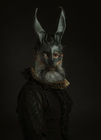 Portrait of rabbit against black background