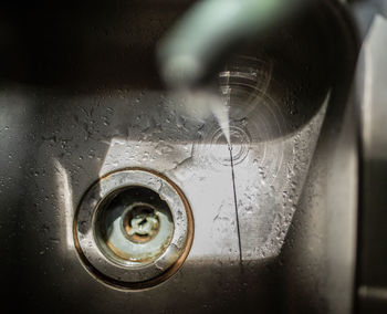 Close-up of water drops on metal at home