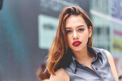 Close-up portrait of beautiful young woman in city