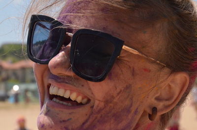 Close-up portrait of smiling wife wearing sunglasses