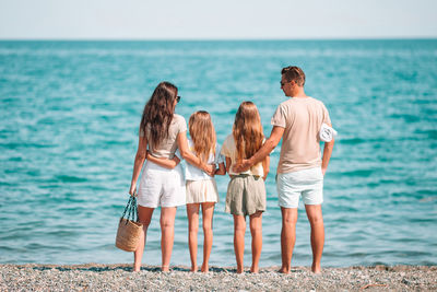 Rear view of people on beach