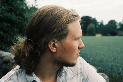 Close-up portrait of young man looking away
