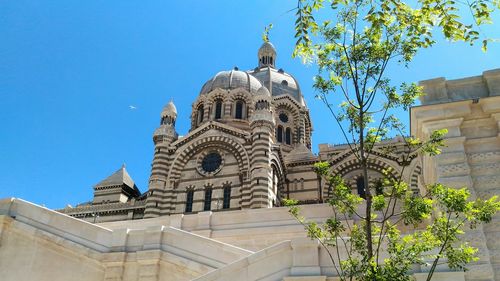 Low angle view of church against blue sky