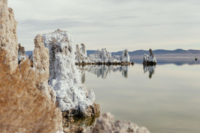 Panoramic view of sea and snowcapped mountains against sky