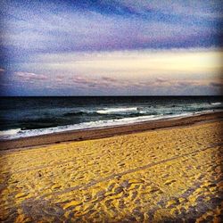 Scenic view of beach against sky during sunset