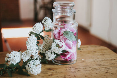 Flowers in jar on table at home