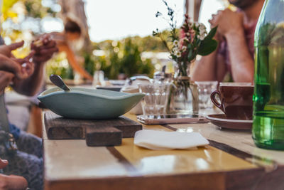 Close-up of people in bowl on table