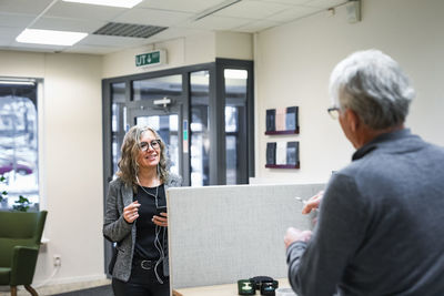 Smiling senior woman entering store