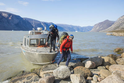 Backpackers disembark boat at the beginning of a through hike.