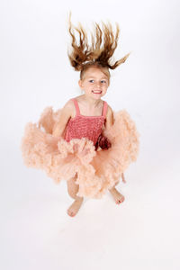 Portrait of smiling girl against white background