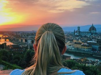 Rear view of woman overlooking cityscape