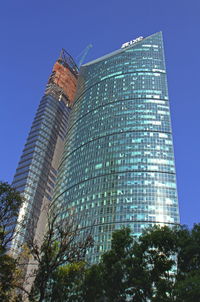 Low angle view of skyscrapers against clear blue sky