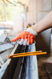  cropped hand of worker holding equipment in workshop