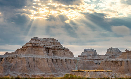 Rock formations against cloudy sky