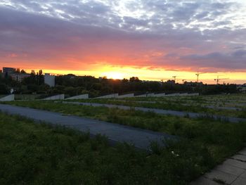 Scenic view of field against cloudy sky