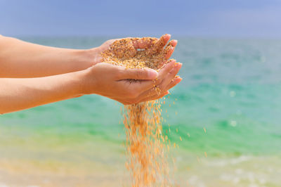 Cropped hand of woman holding water